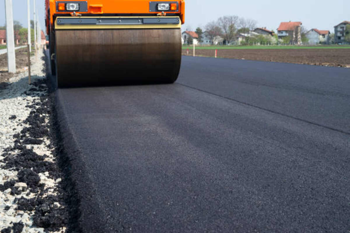 asphalt paving steamroller machine flattening new layer of asphalt road construction